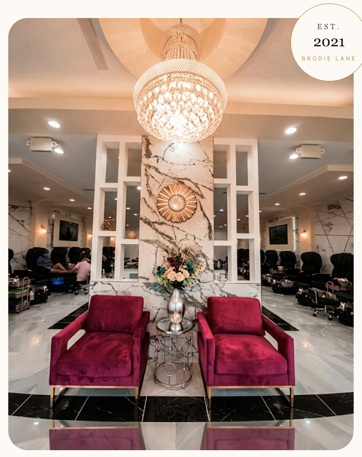 Le Posh Nail Spa interior — crystal chandelier, marble accents, and velvet rose lounge chairs at our Brodie Lane studio